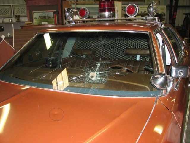 The broken car of officer Val Johnson. The front windscreen is severely broken. 